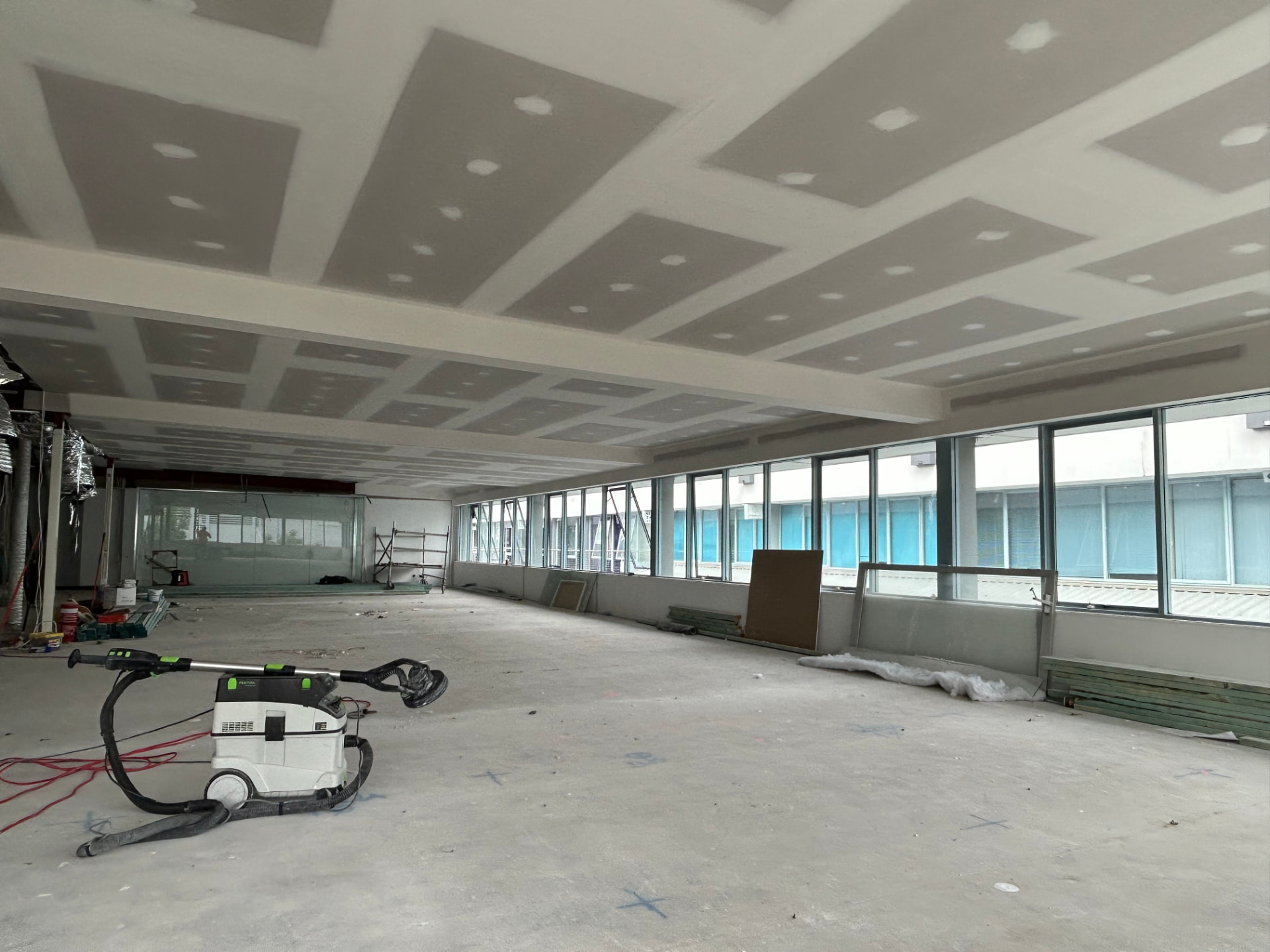 Large open-plan commercial interior with coffered plasterboard ceiling in Sydney